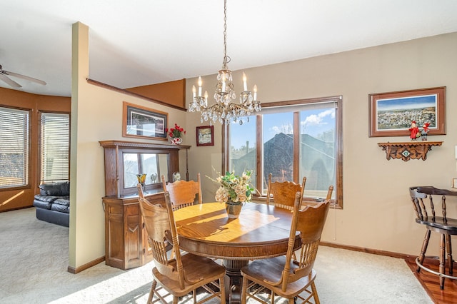 dining room featuring baseboards, a mountain view, and light colored carpet