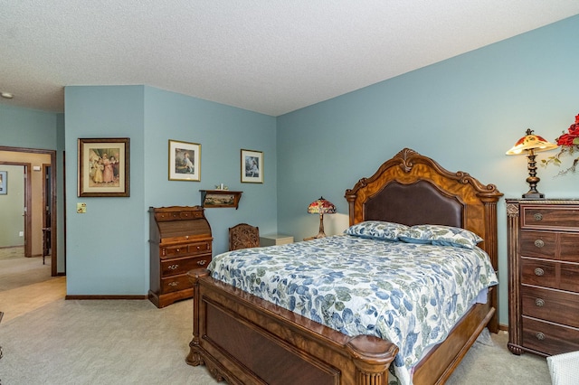 bedroom with light carpet, a textured ceiling, and baseboards