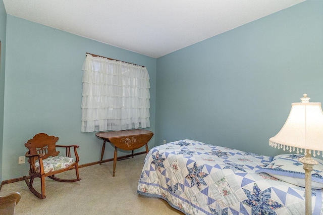 bedroom featuring carpet floors and baseboards