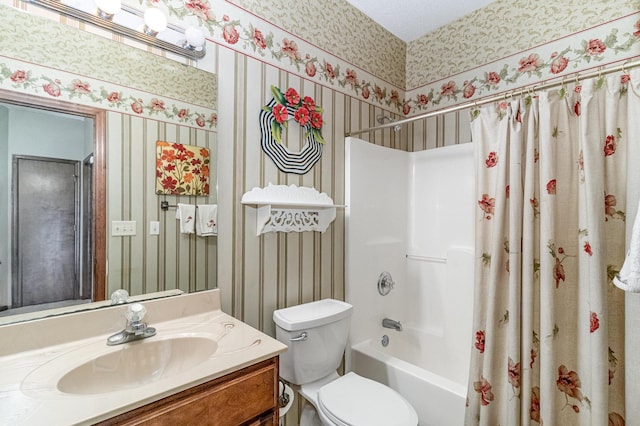 bathroom with shower / tub combo, wallpapered walls, toilet, and vanity