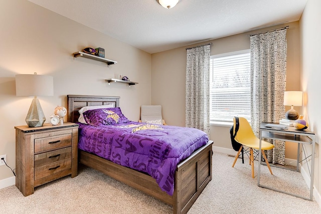 bedroom featuring light carpet and baseboards