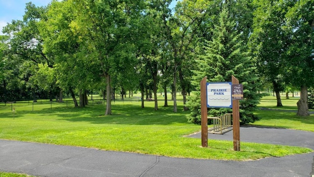 view of property's community featuring fence and a yard