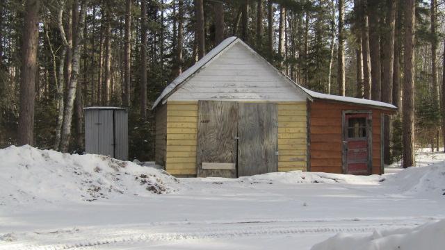 snow covered structure with an outdoor structure