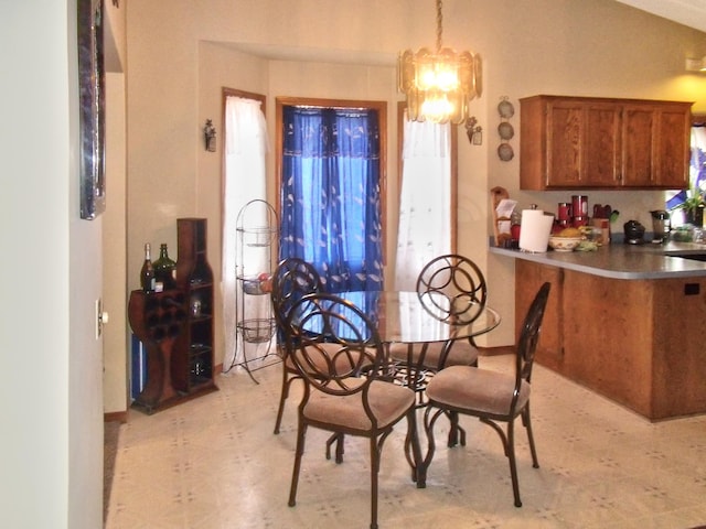 dining space featuring light floors and a notable chandelier