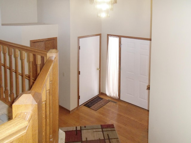 foyer entrance featuring stairway and wood finished floors