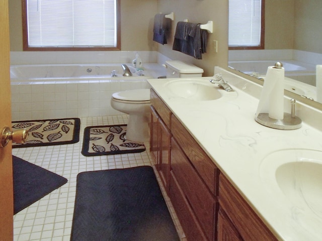 bathroom featuring double vanity, toilet, a garden tub, tile patterned flooring, and a sink