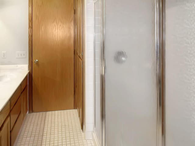 full bathroom featuring a shower stall, vanity, and tile patterned floors