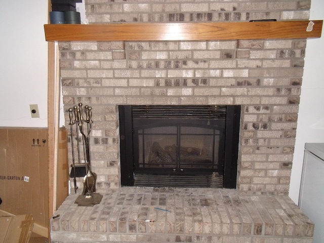 interior details with a wainscoted wall and a fireplace