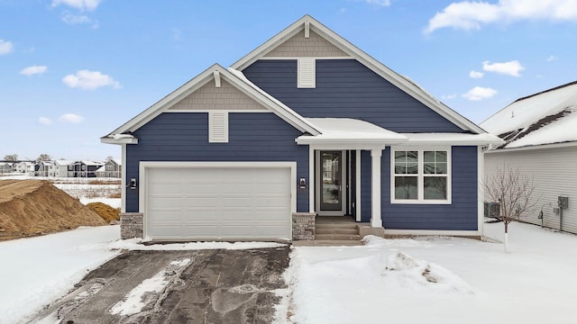 view of front of house with a garage and stone siding