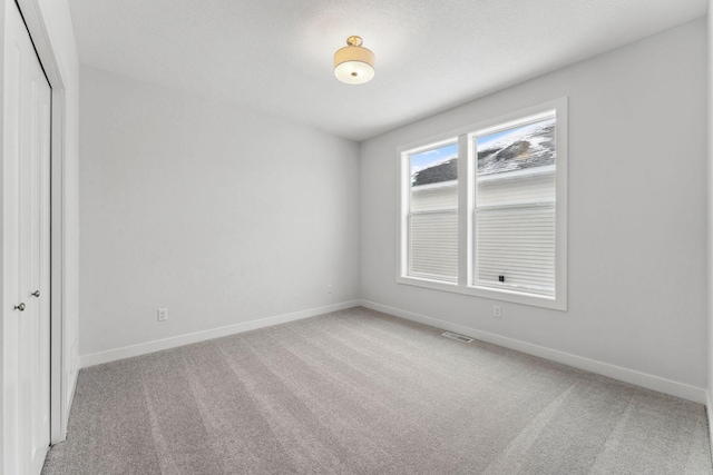 4870 127th Ln NE, Blaine, MN 55449 - spare room featuring carpet flooring and baseboards