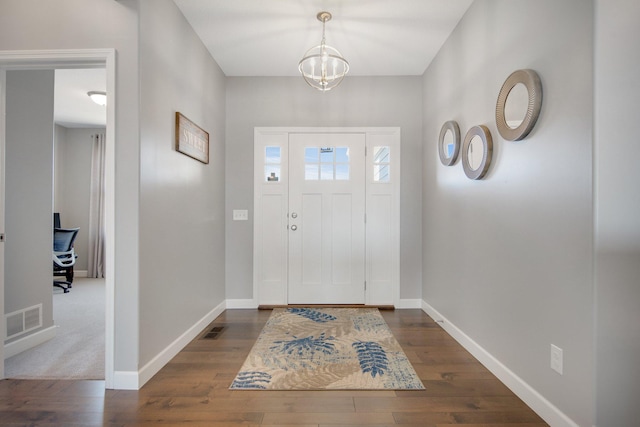 entrance foyer featuring visible vents, baseboards, and dark wood-style floors