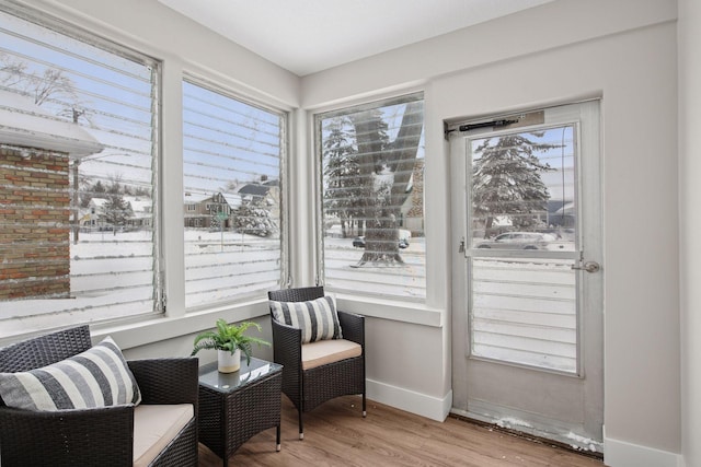 sitting room with baseboards and wood finished floors