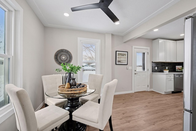 dining space with baseboards, ceiling fan, recessed lighting, and light wood-style floors