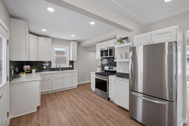 kitchen featuring open shelves, light wood-style flooring, white cabinets, and stainless steel appliances