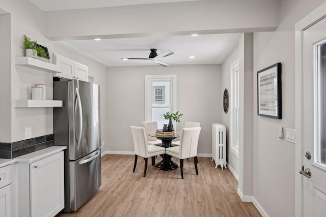 dining room with light wood-type flooring, baseboards, radiator heating unit, and recessed lighting