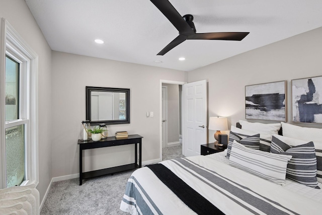 bedroom with baseboards, recessed lighting, and light colored carpet