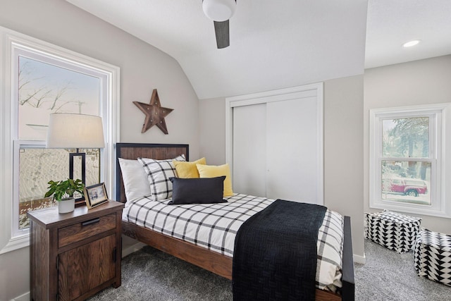 bedroom featuring lofted ceiling, ceiling fan, carpet flooring, baseboards, and a closet