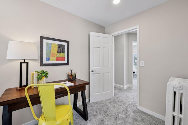 carpeted home office featuring baseboards