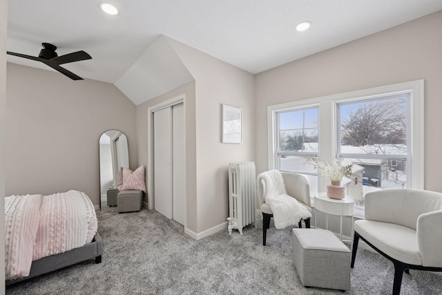 bedroom with carpet, lofted ceiling, a closet, radiator heating unit, and baseboards