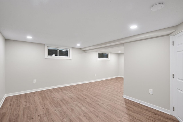 below grade area with baseboards, wood finished floors, and recessed lighting