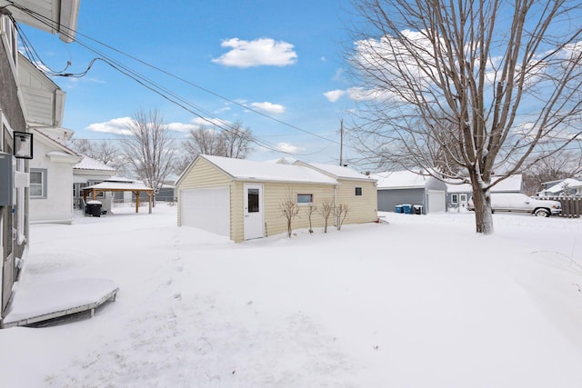 exterior space featuring a garage and an outbuilding