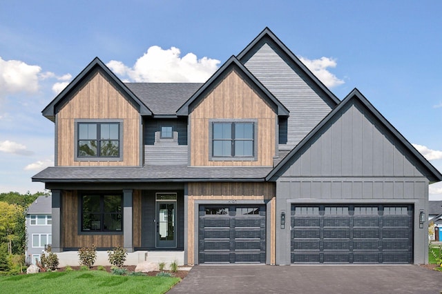 modern inspired farmhouse featuring aphalt driveway and roof with shingles