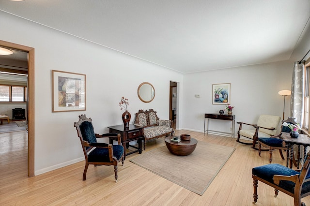 sitting room featuring light wood-style flooring and baseboards