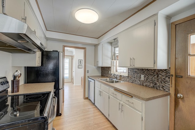 kitchen with stainless steel appliances, light countertops, white cabinetry, a sink, and under cabinet range hood