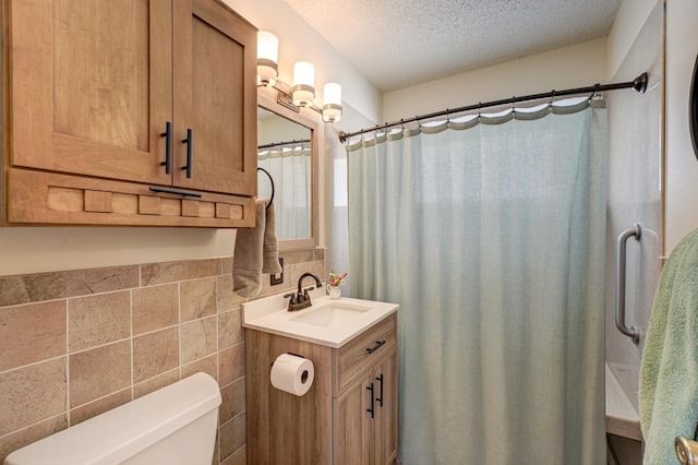 bathroom featuring tile walls, a shower with shower curtain, toilet, a textured ceiling, and vanity