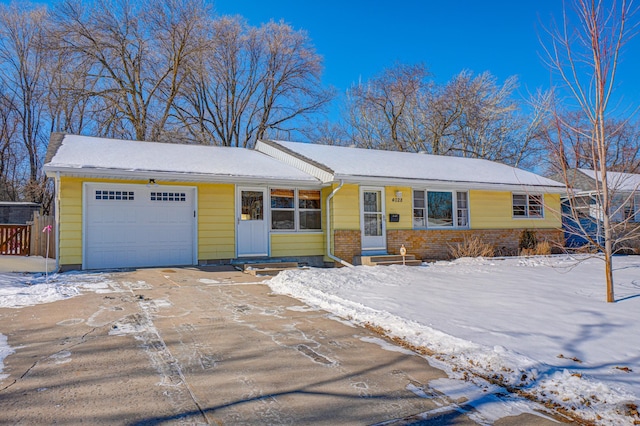 single story home featuring a garage, entry steps, and brick siding