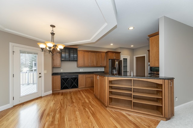 kitchen featuring black dishwasher, stainless steel fridge, baseboards, brown cabinetry, and open shelves