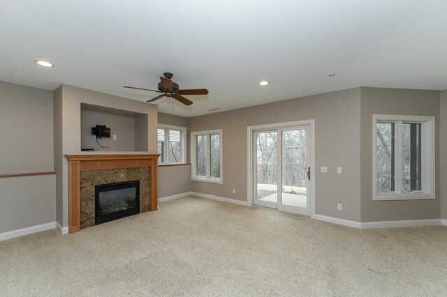 unfurnished living room with ceiling fan, recessed lighting, carpet flooring, baseboards, and a tiled fireplace