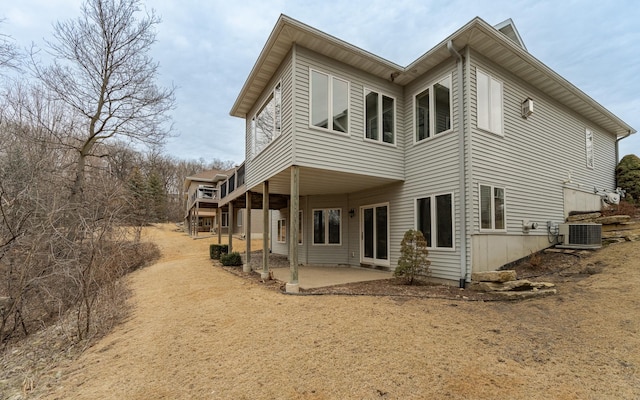 back of house featuring a patio and cooling unit