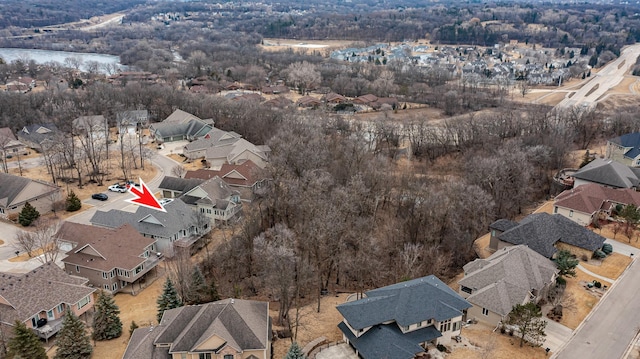 drone / aerial view with a water view and a residential view