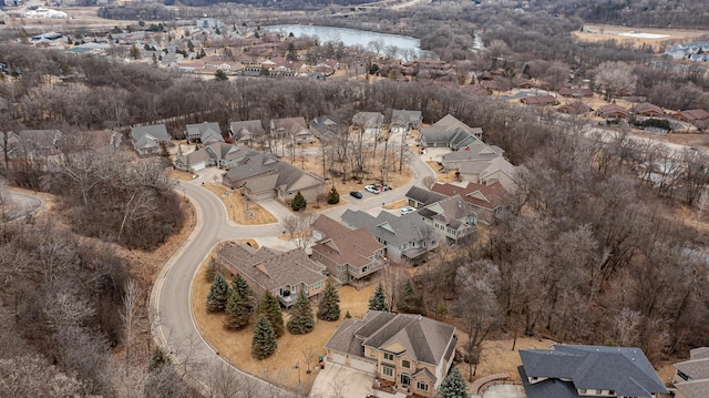 drone / aerial view with a water view and a residential view