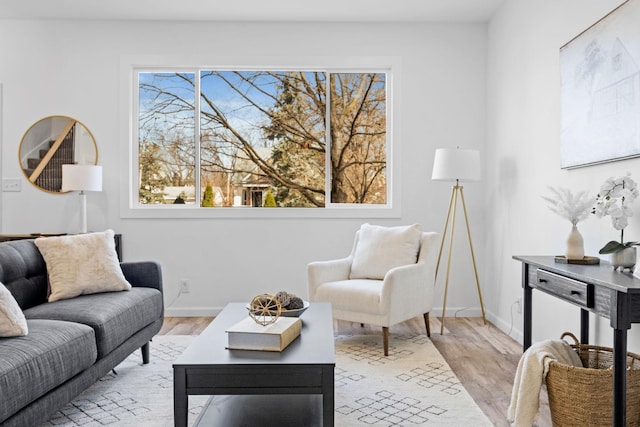 living room with plenty of natural light, light wood-style flooring, and baseboards