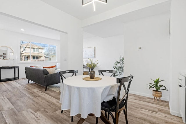 dining space featuring light wood-style flooring, baseboards, and recessed lighting