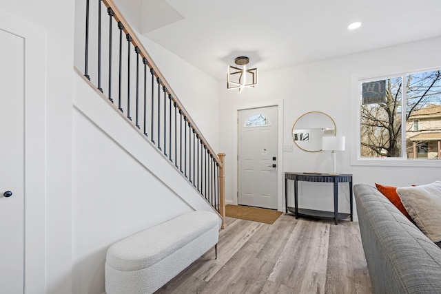 entrance foyer with light wood-style floors, recessed lighting, stairway, and baseboards