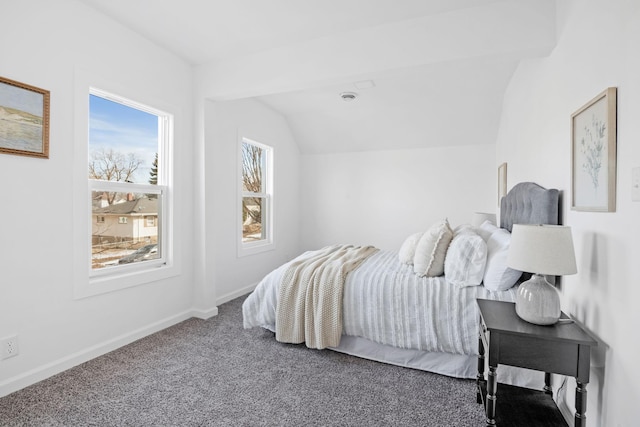 carpeted bedroom with lofted ceiling and baseboards