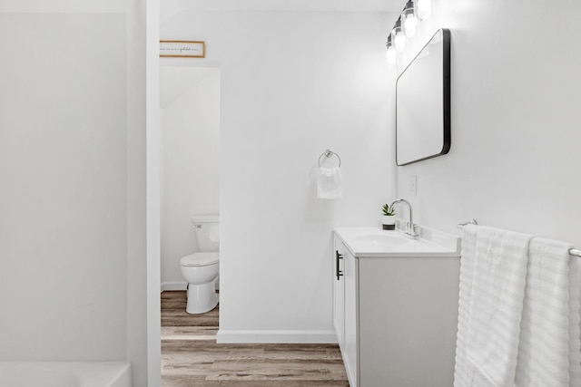 full bath featuring baseboards, vanity, toilet, and wood finished floors