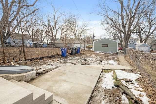 yard covered in snow with fence and a residential view