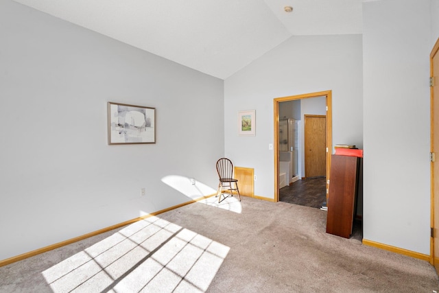 unfurnished bedroom with carpet floors, baseboards, and lofted ceiling