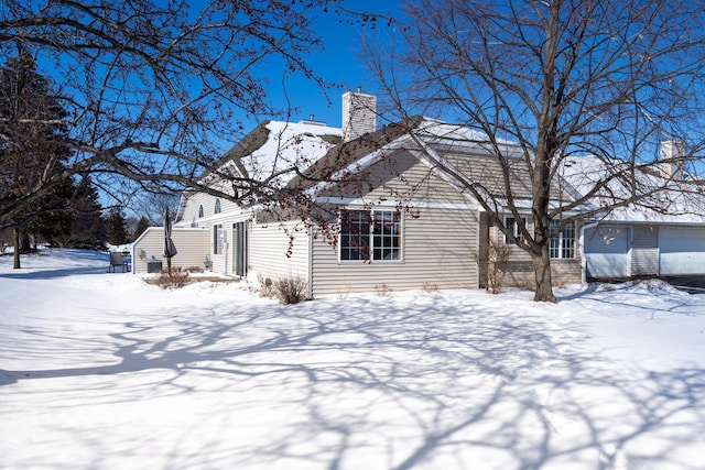 exterior space featuring a garage and a chimney