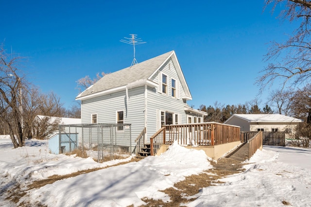 view of snow covered exterior featuring a wooden deck