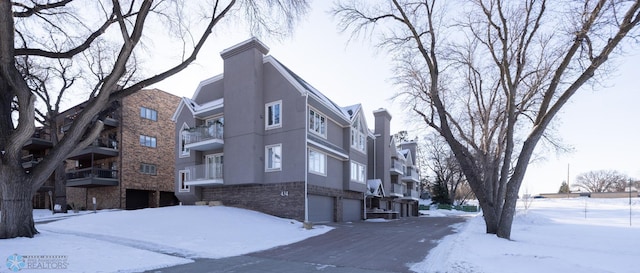 snow covered building with an attached garage