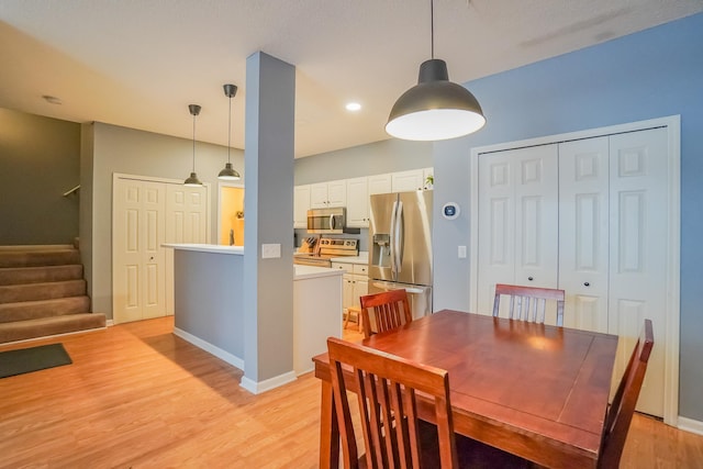 dining room with baseboards, stairway, recessed lighting, and light wood-style floors