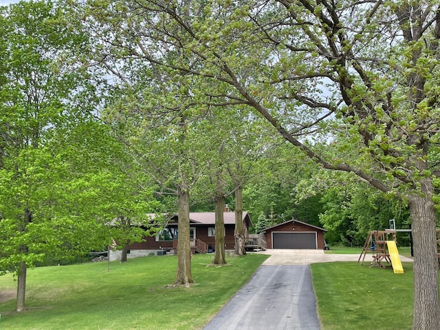 19241 Ebony Rd, Osakis, MN 56360 - view of front of house with an outbuilding, a garage, a front yard, and a playground