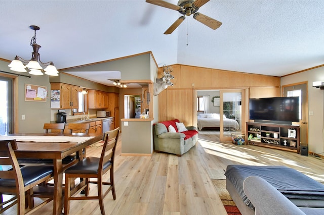 19241 Ebony Rd, Osakis, MN 56360 - dining space with lofted ceiling, light wood-type flooring, a ceiling fan, wooden walls, and a chandelier