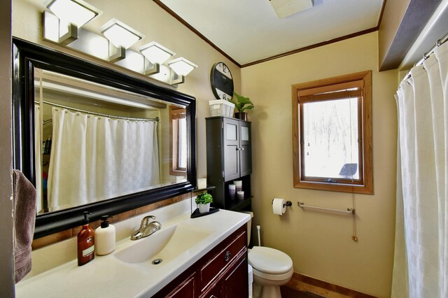 19241 Ebony Rd, Osakis, MN 56360 - bathroom with crown molding, toilet, vanity, and baseboards