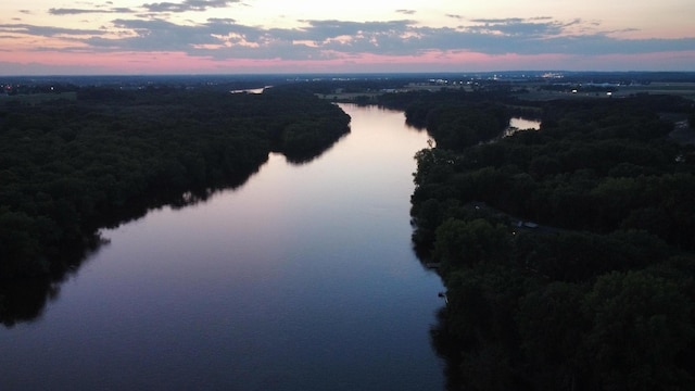 aerial view with a water view and a wooded view